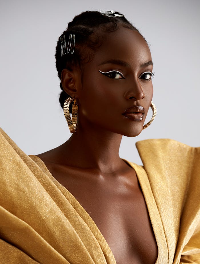 my-steps Stunning portrait of a woman in a glamorous gold dress, showcasing elegance and style.