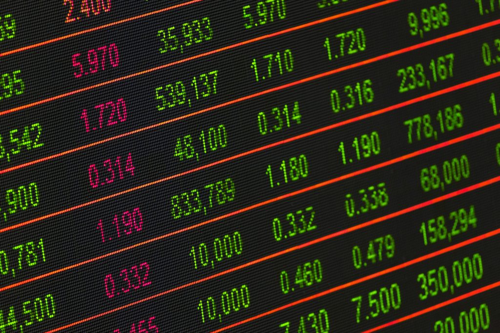 pexels photo 210607 210607 Close-up of a digital stock market data display showing colorful financial numbers and trends.